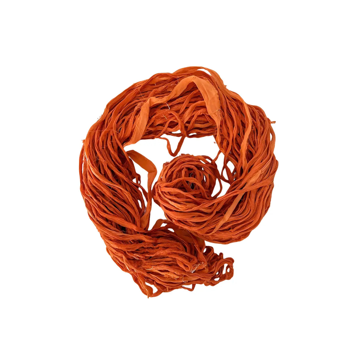 Loosely coiled hank of rust-orange recycled sari silk chiffon ribbon yarn, Burnt Sienna Blend colorway
