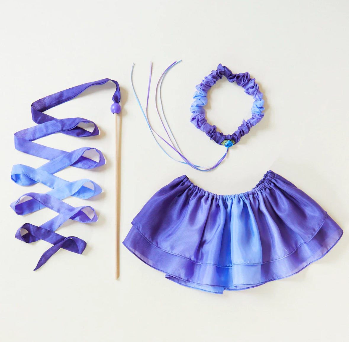 Butterfly colorway tutu, garland, and silk streamer toy on light background