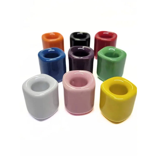 colorful ceramic taper candle holders on a white background