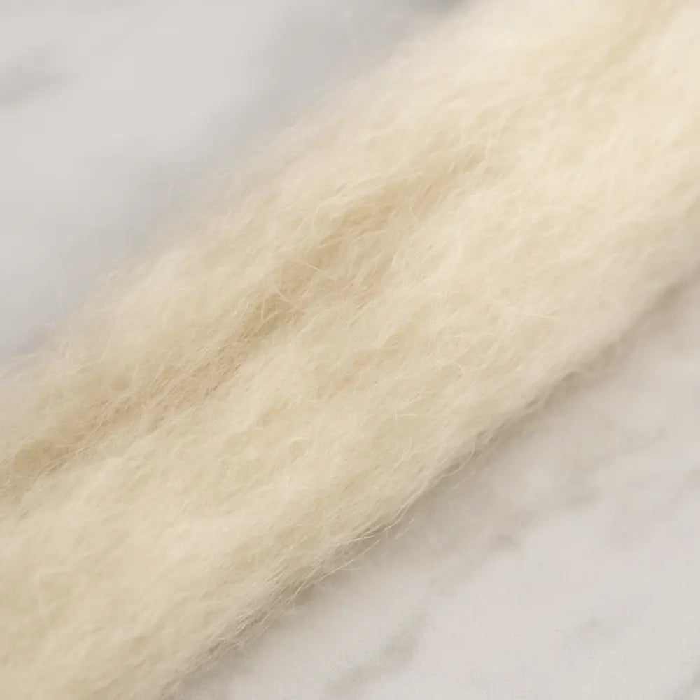 Close up of Undyed superfine Merino wool sliver fiber for spinning and felting