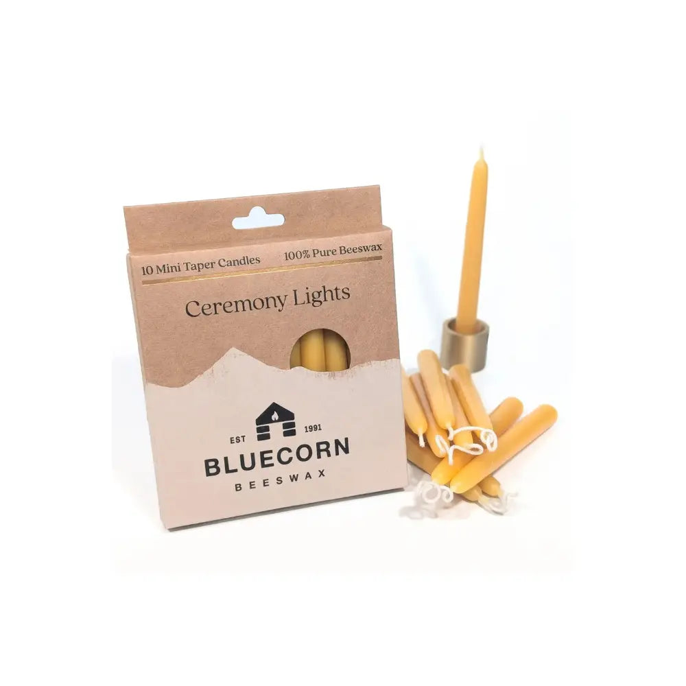 Bluecorn Beeswax mini taper candles with packaging on a white background