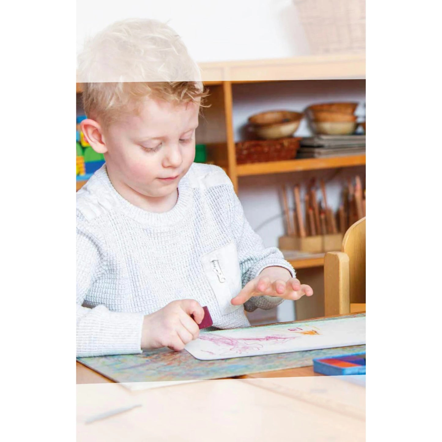 child drawing with Stockmar beeswax crayons using stick crayons on paper