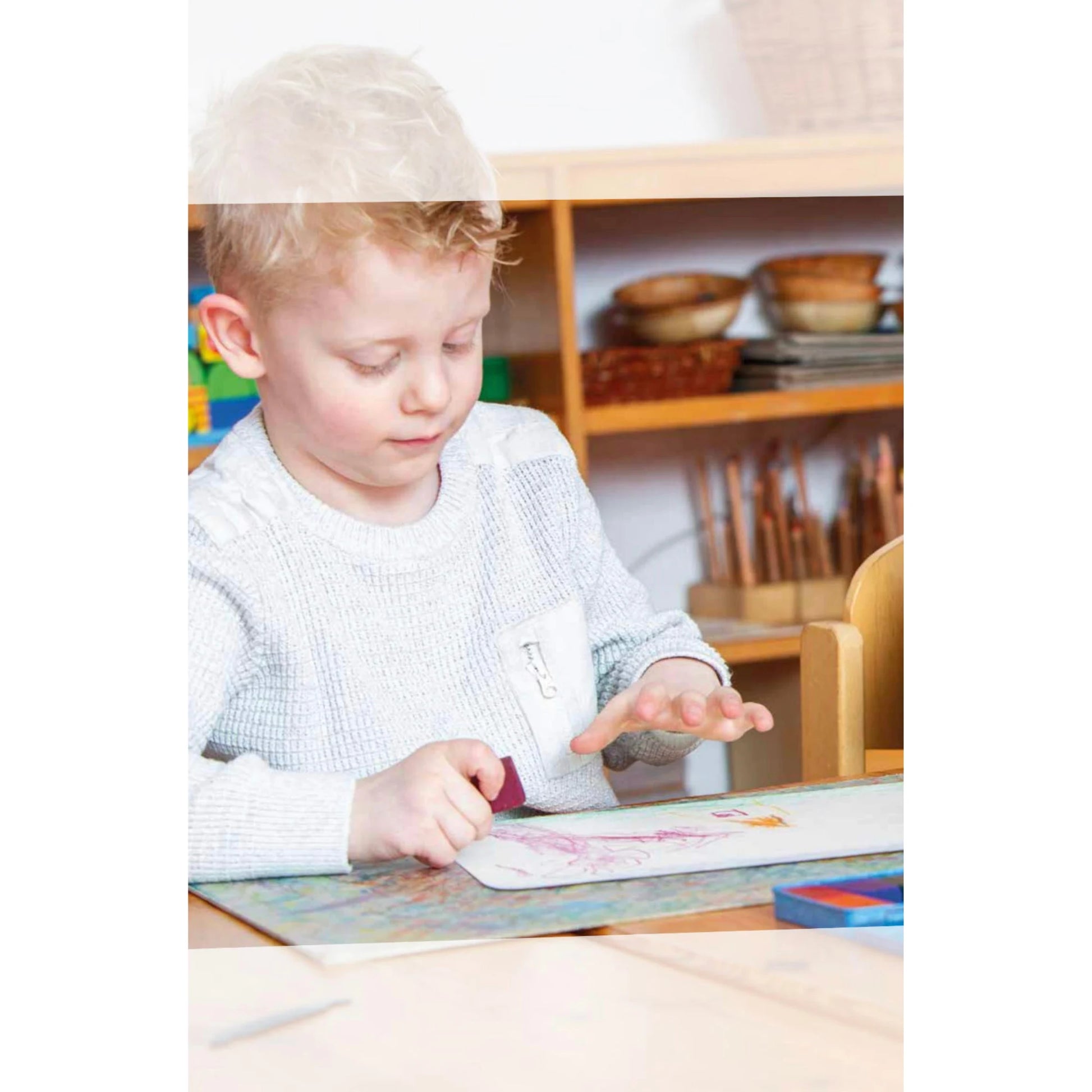child drawing with Stockmar beeswax crayons using stick crayons on paper