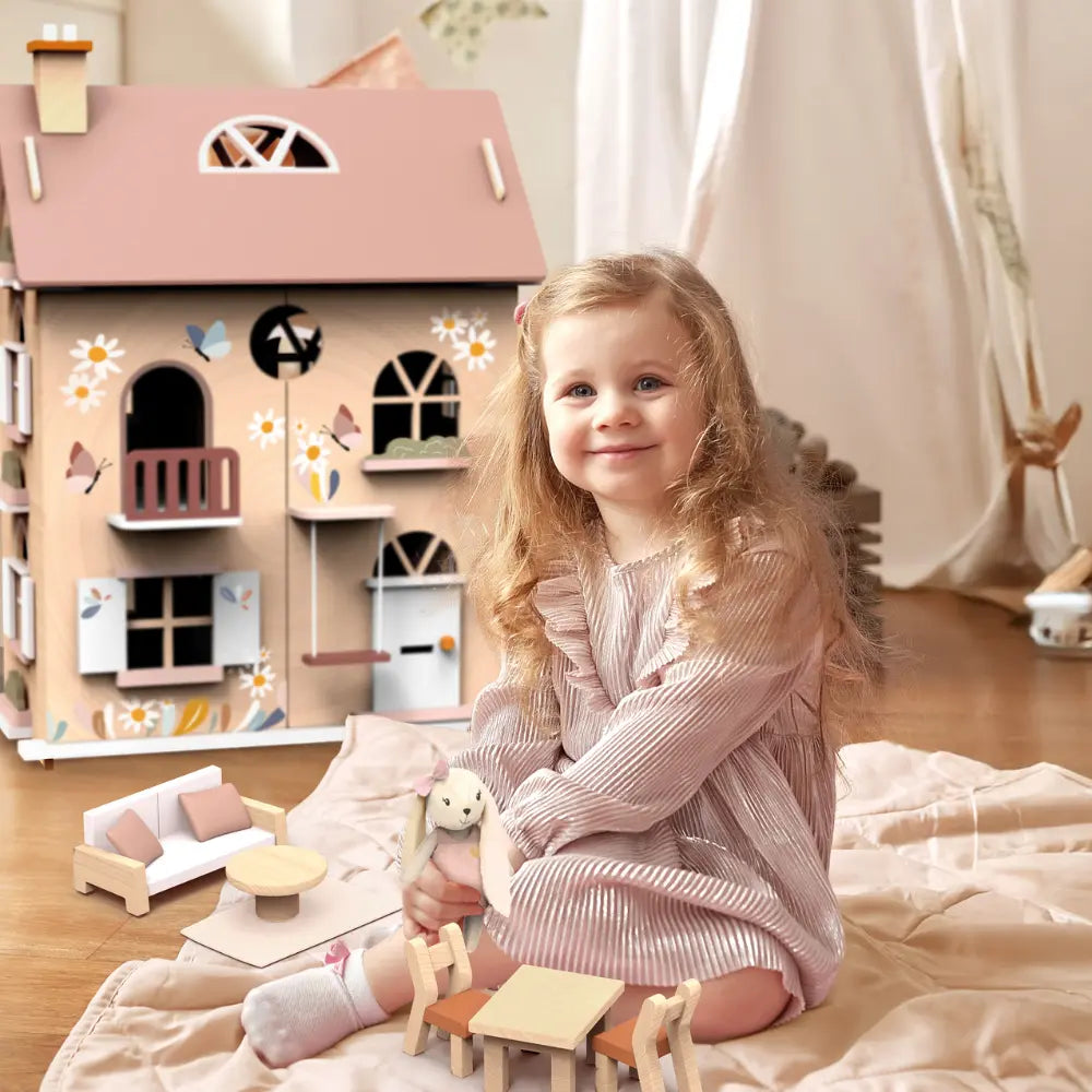 Child playing with wooden dollhouse and bunny character in bedroom imaginative play scene