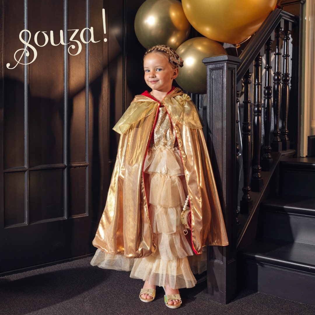 Child wearing gold reversible cape for dress-up and imaginative play