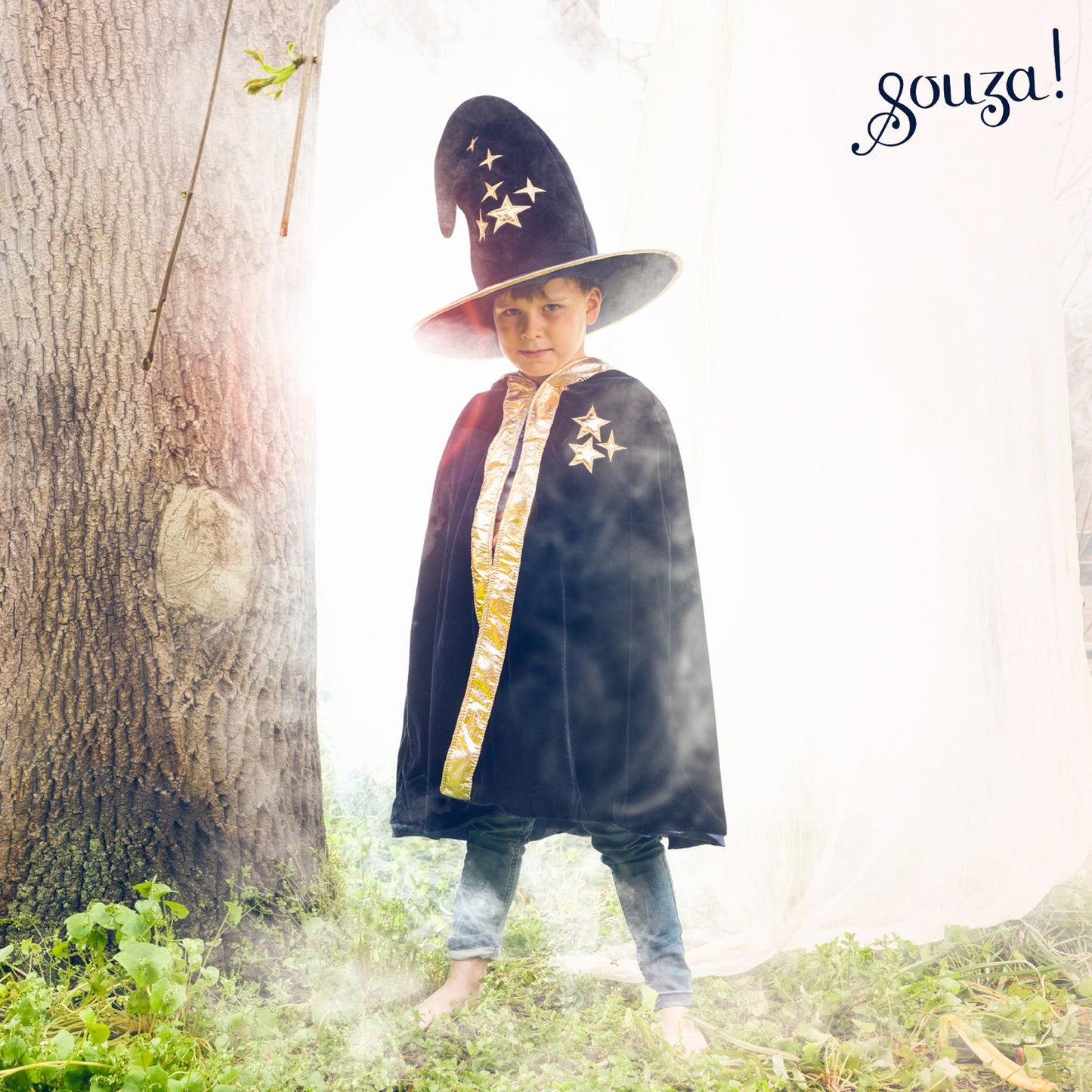 Child wearing blue magician cape with hood for imaginative outdoor dress-up play