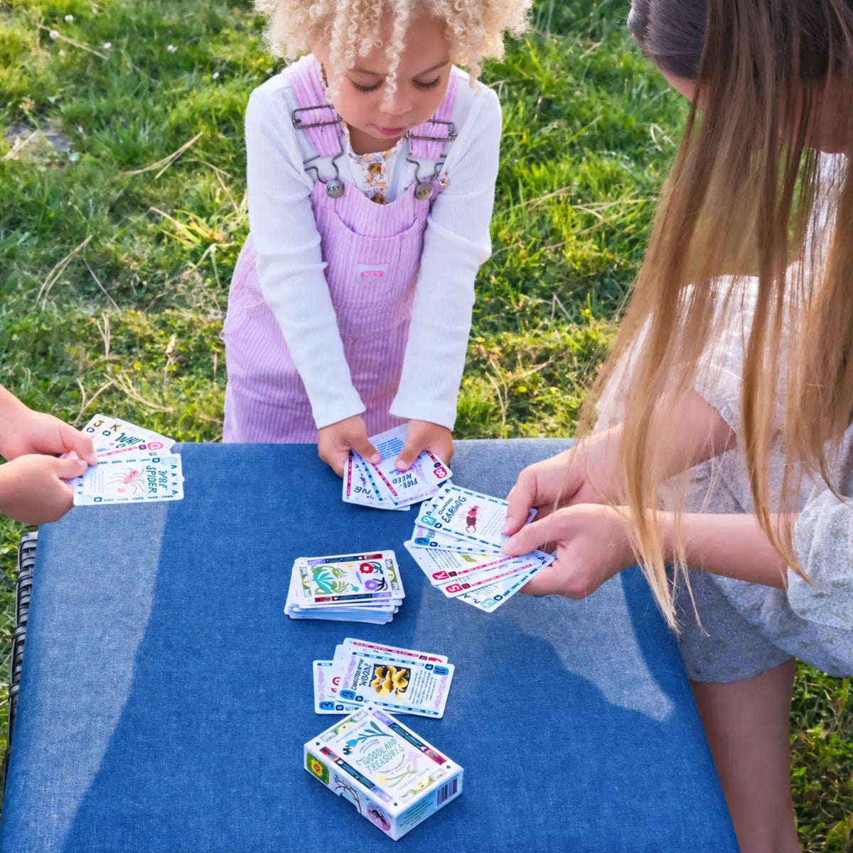 Kids playing Wild Forage Woodland Treasures card game