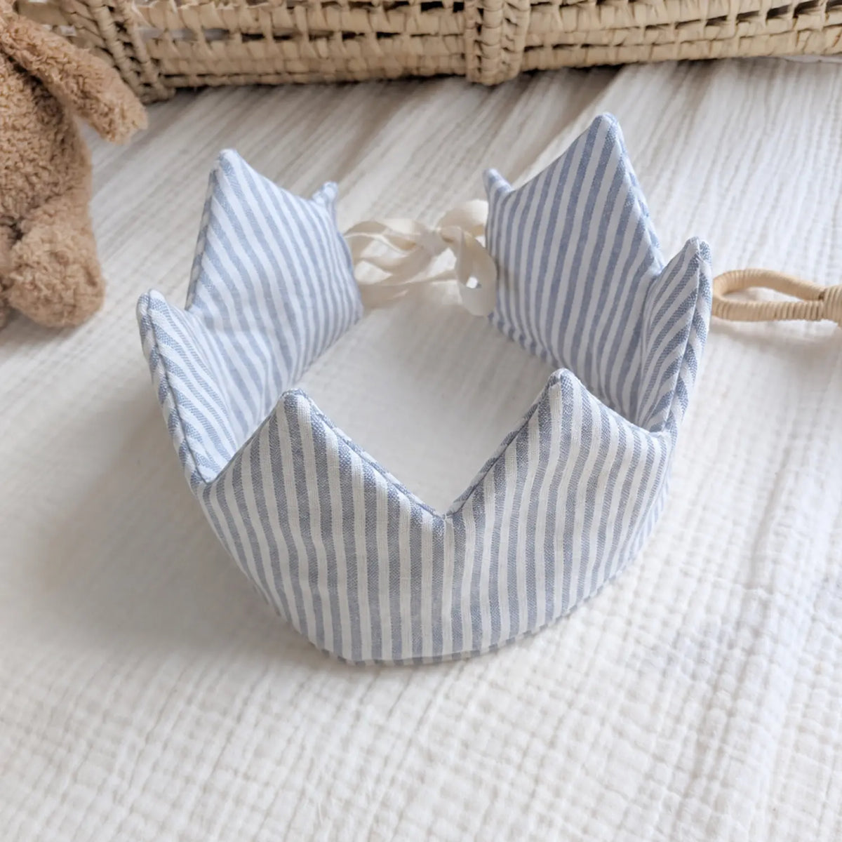 Blue striped natural linen dress-up crown top view with adjustable ties for children