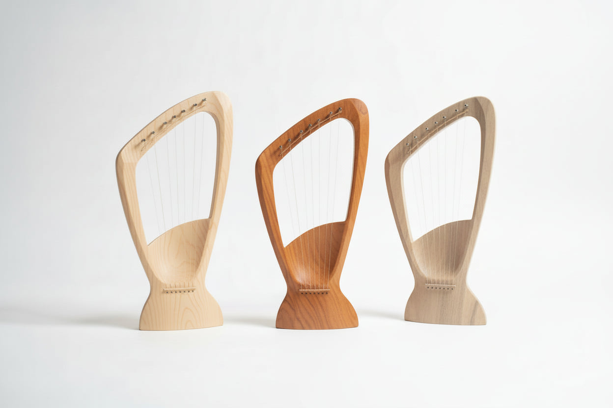 Three wooden lyre-shaped objects on a table with a neutral background