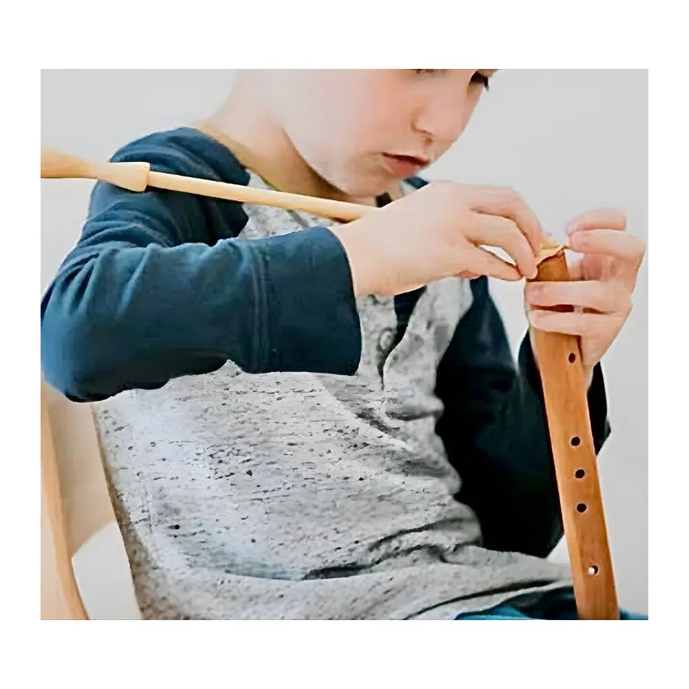 Person swabbing a wooden choroi flute with a blurred background