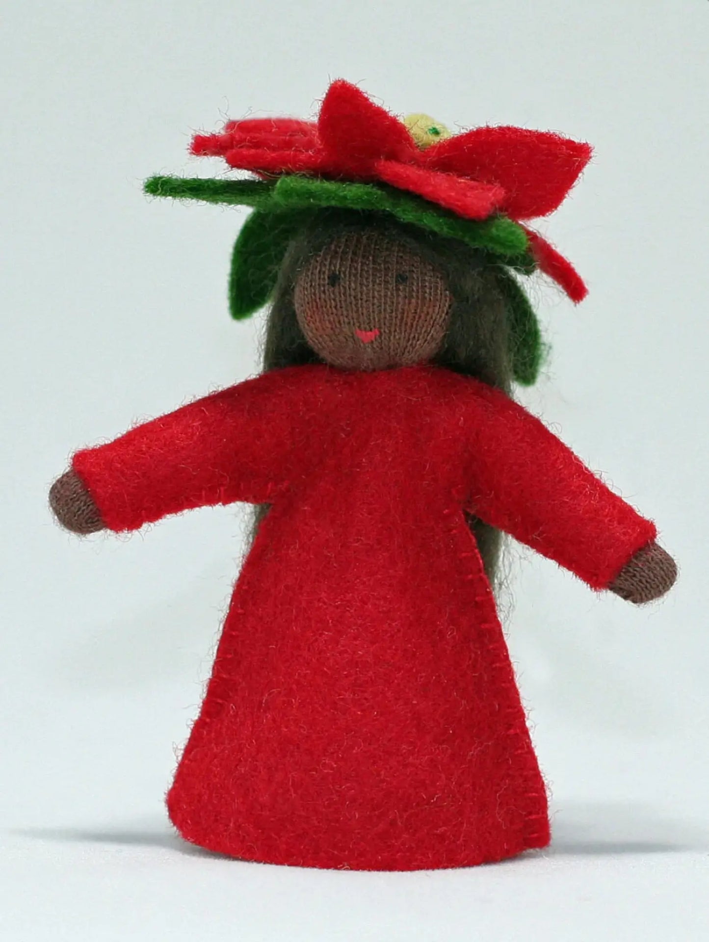Dark skin tone flower fairy doll with a red dress and green hat on a white background
