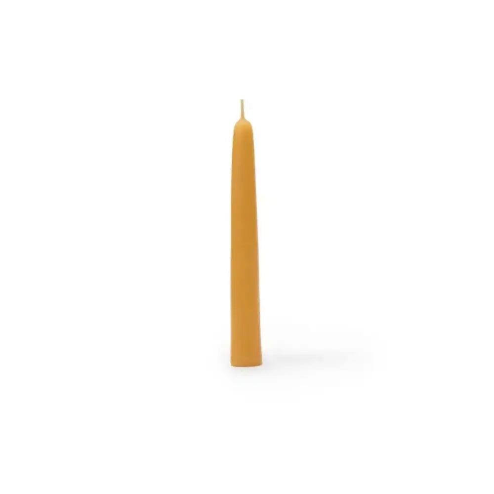 Single yellow candle on a white background