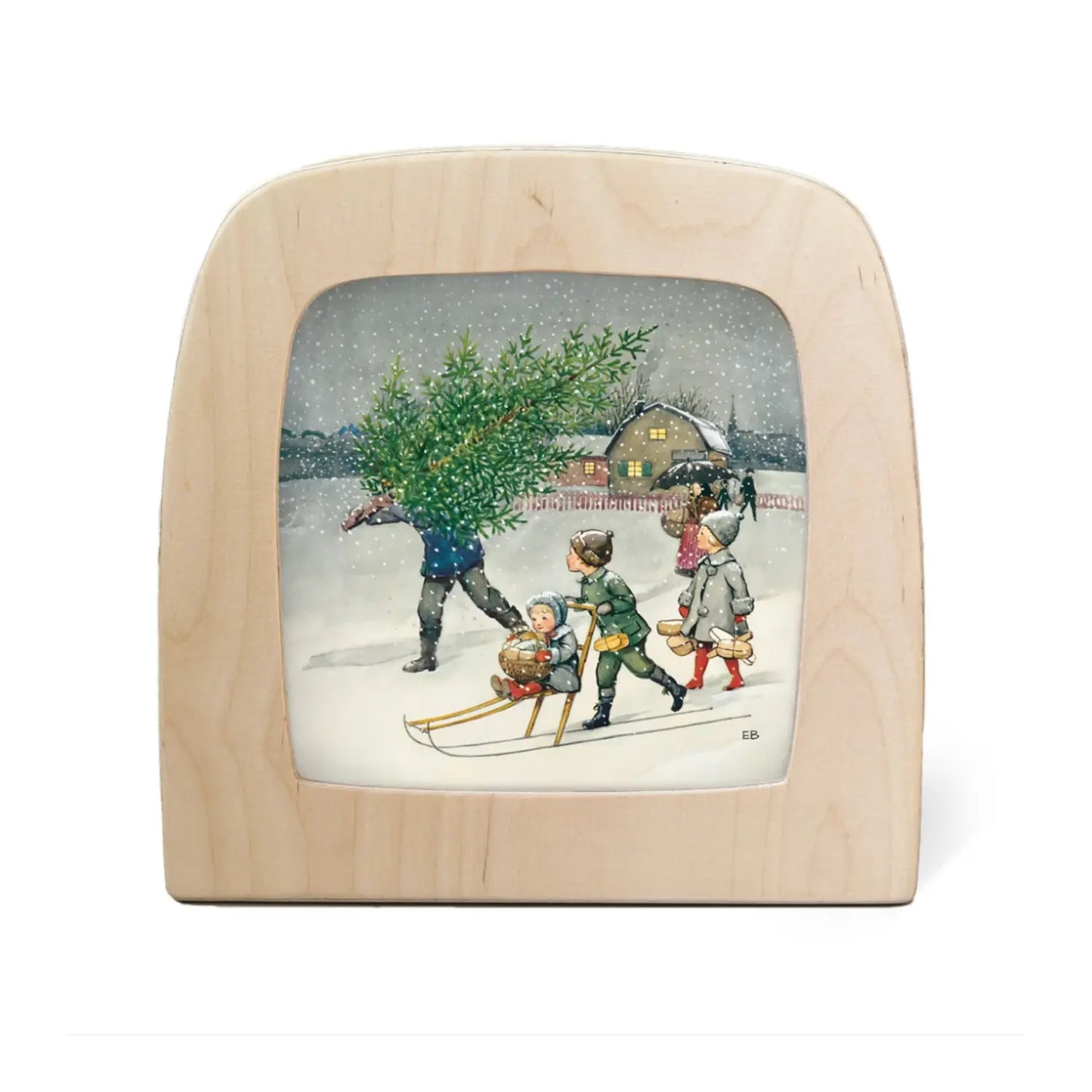 A Toverlux magic lamp plate scene of a family and a Christmas tree in the snow from Elsa Beskow's Around the Year Book