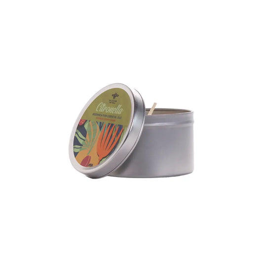 Candle in a metal tin with a colorful label on a white background