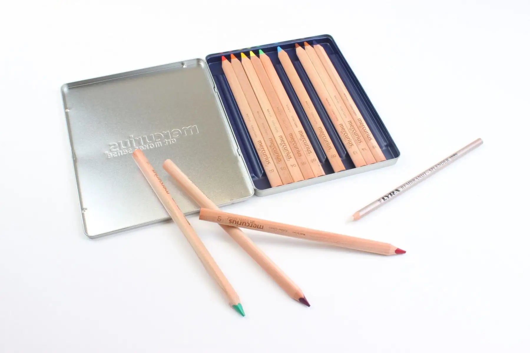 Set of Mercurius Art Makes Sense colored pencils with splender and a metal case on a white background