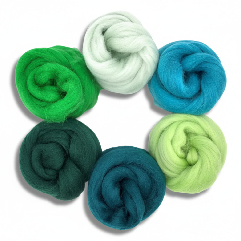 Set of six skeins of green and blue yarn on a white background