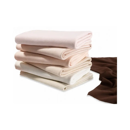 stack of folded cotton dollmaking fabrics