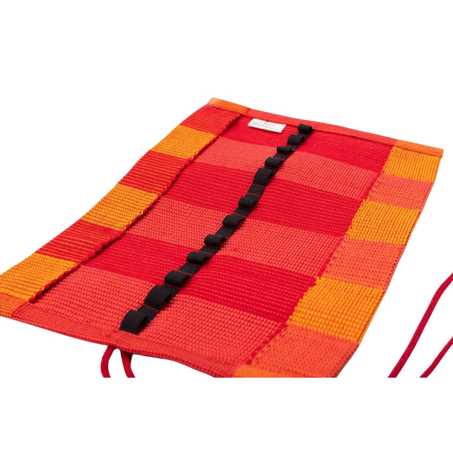 Red and orange checkered crayon roll for thick crayons with a black strap on a white background