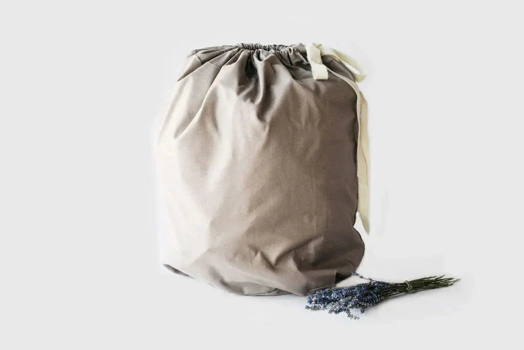  Cotton and Wool sleeping bag in duffle bag on light background