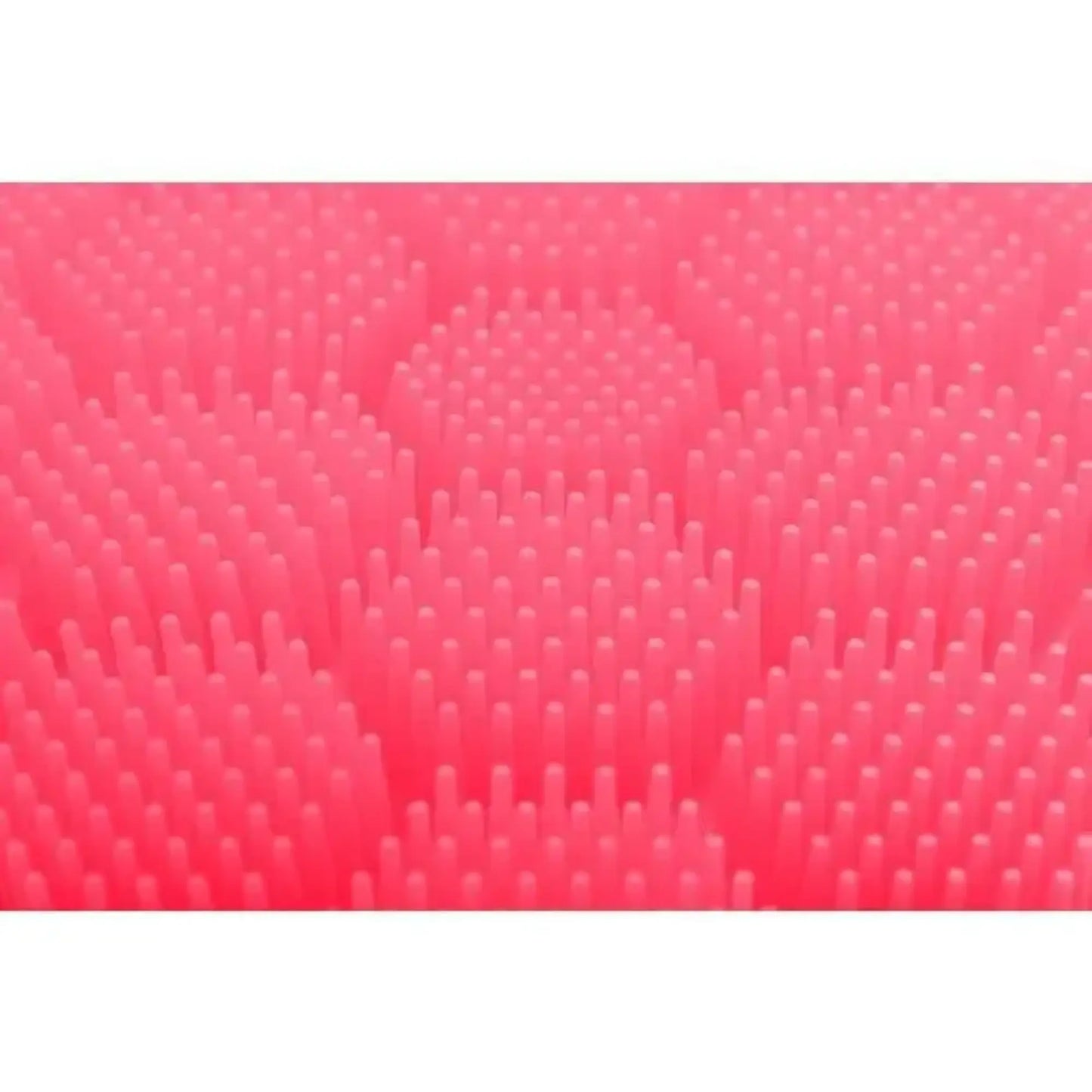 Close up of the pink raised textured surface of the soft silicone scrubber for cradle cap, hair washing, hand washing for children