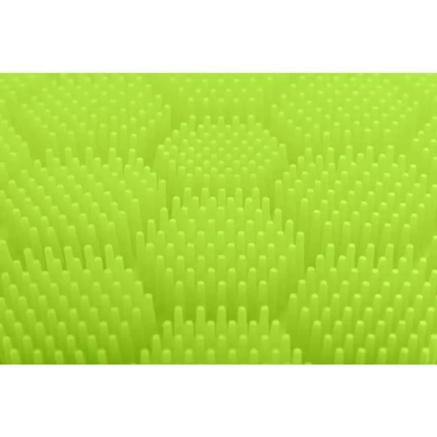 Close up of the green raised textured surface of the soft silicone scrubber for cradle cap, hair washing, hand washing for children