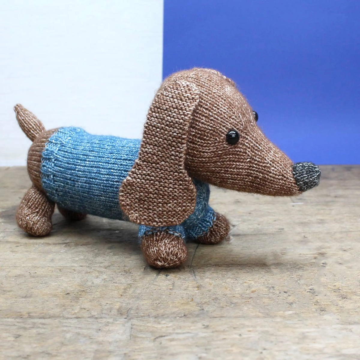 Hand-knit dachshund soft toy with blue sweater from Scheepjes yarn kit
