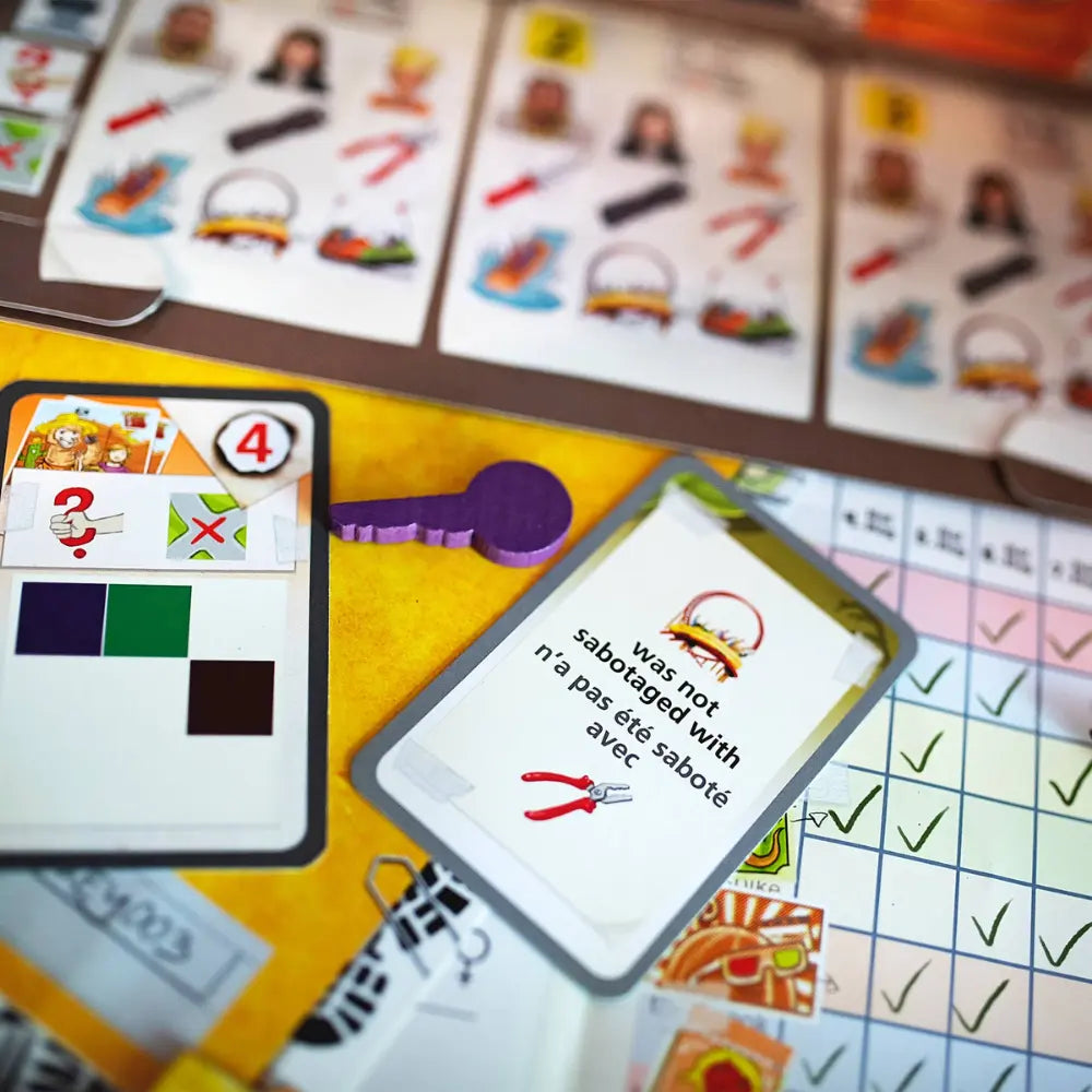 Deduction board game cards close up with colorful illustrations and text 