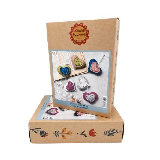 Cardboard box with heart-shaped craft items and Corinne Lapierre branding on a white background