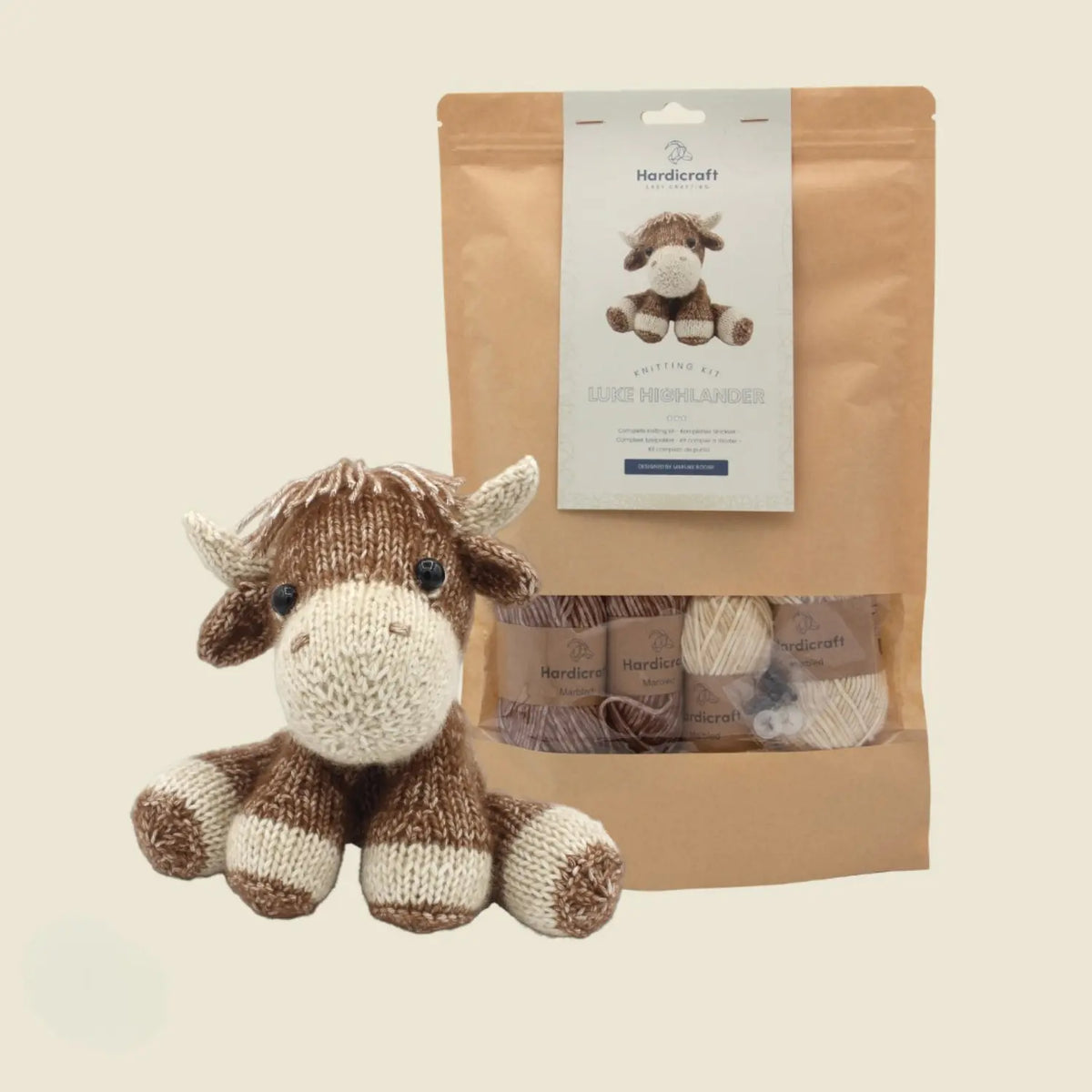Hardicraft Luke Highlander DIY knitting kit shown with the finished knitted Highland cow