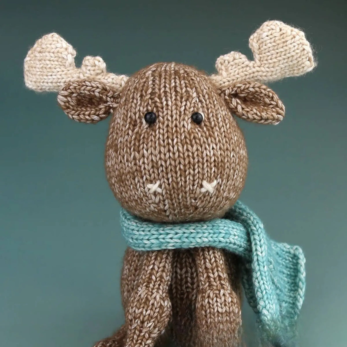 Maddie Moose knitting kit contents with pattern, Hardicraft Marbled yarn, stuffing, safety eyes, and finished moose