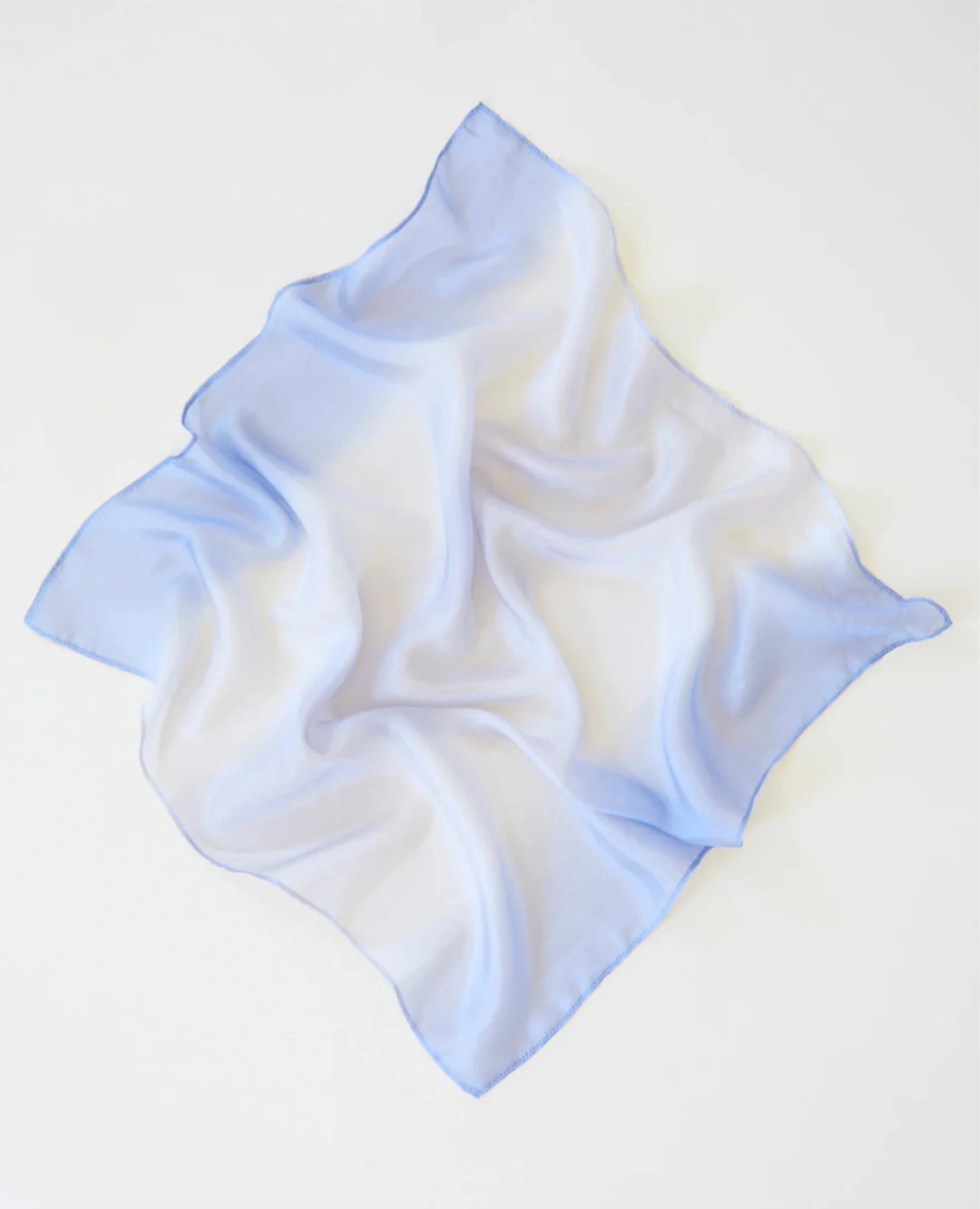 Earth playsilk in stone spread out as a square on a light background