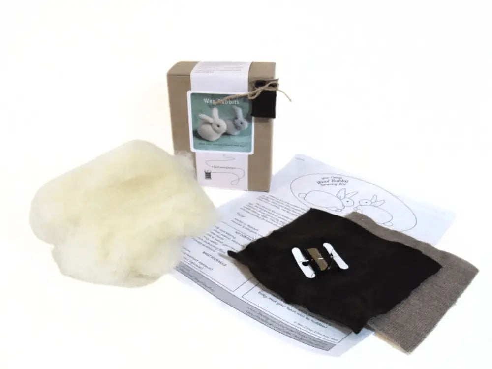 Crafting kit with wool, tools, and instructions on a white background
