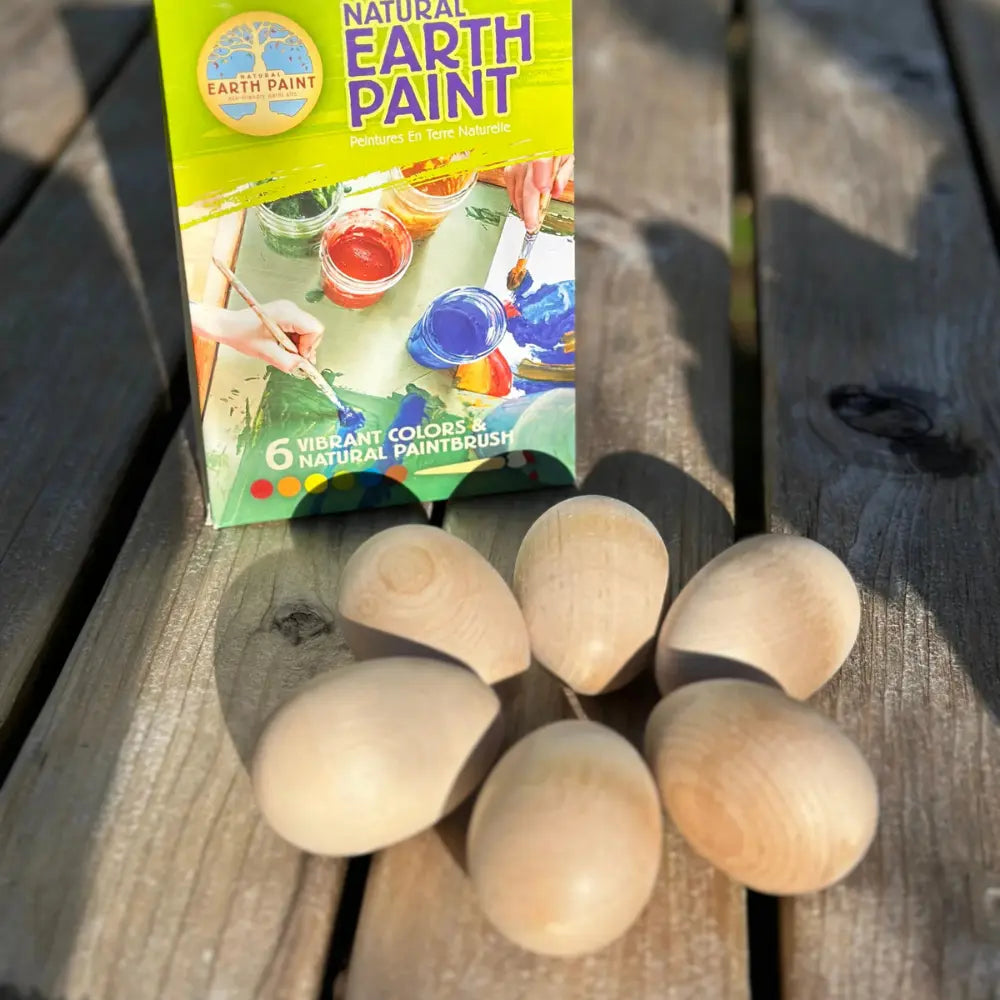 Earth Paint packaging with wooden eggs on a wooden surface