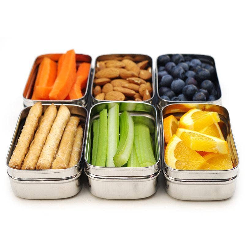 ECOlunchbox stainless steel snack containers packed with vegetables, crackers, nuts, blueberries, and orange slices