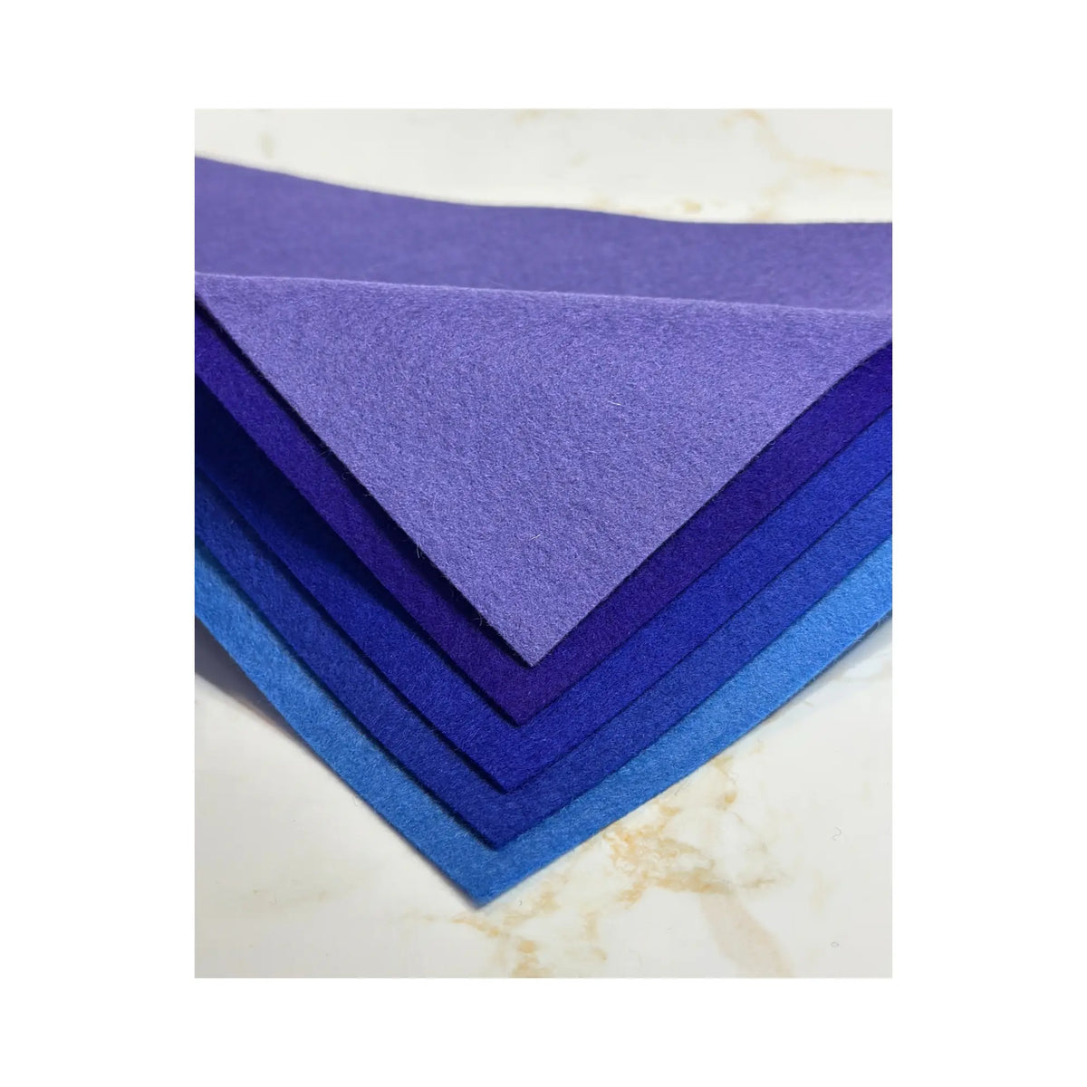 100% Wool Felt sheets in layers showing purples and blues
