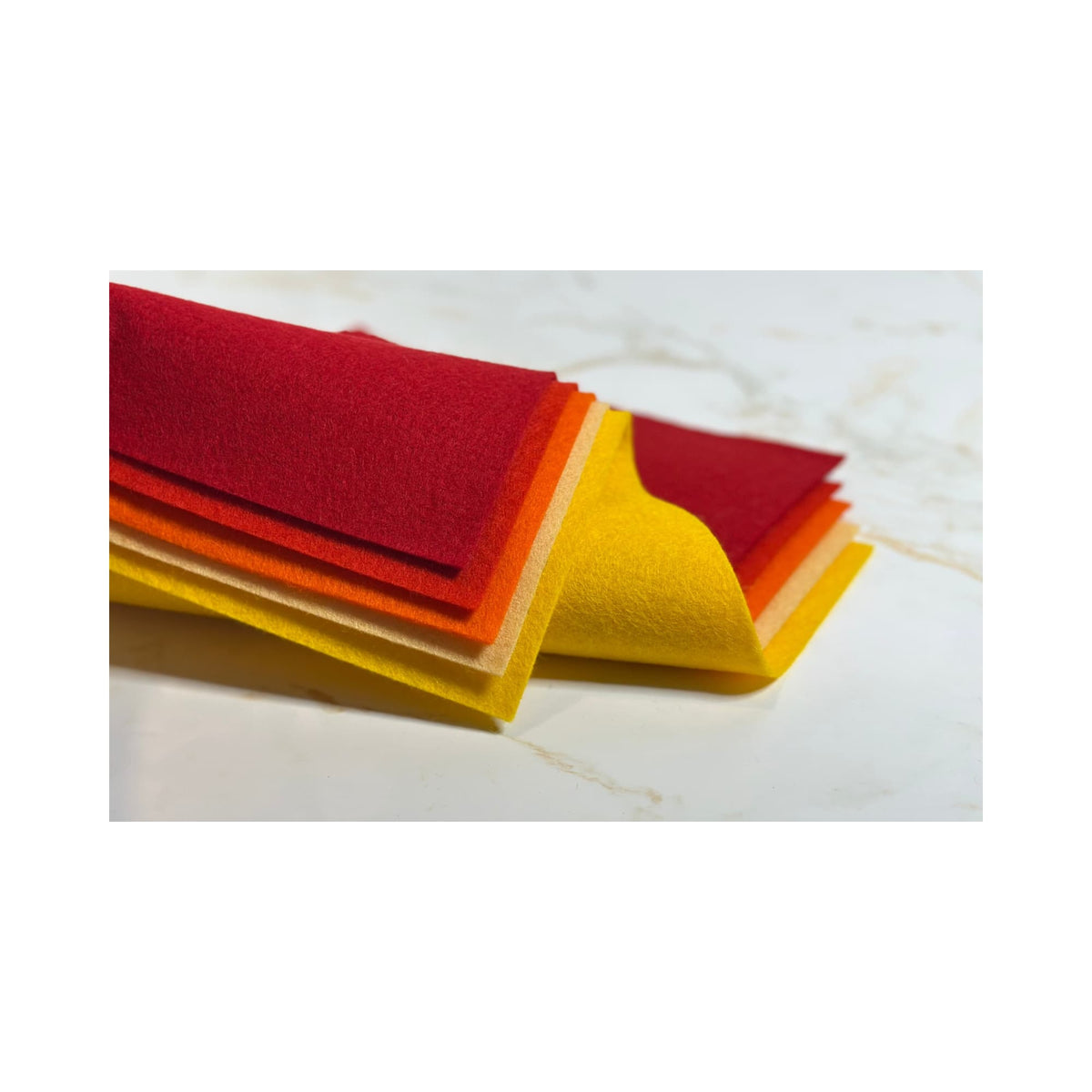 100% Wool Felt sheets layered to show golden yellow, yellow, orange, vermilion, and red