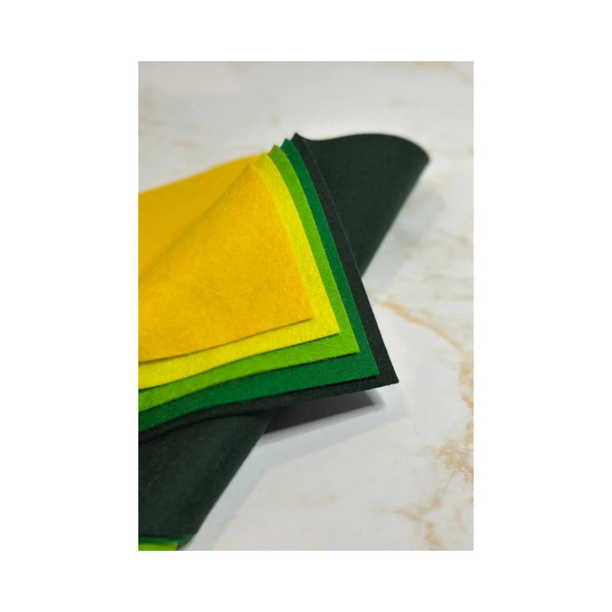 100% Wool Felt sheets in layers showing yellows and greens