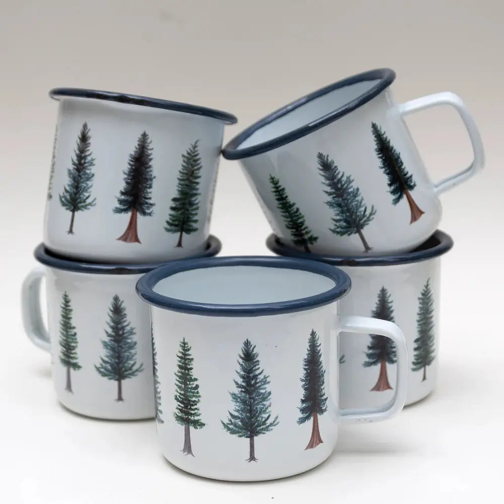 Set of four enamel mugs with tree design on a white background
