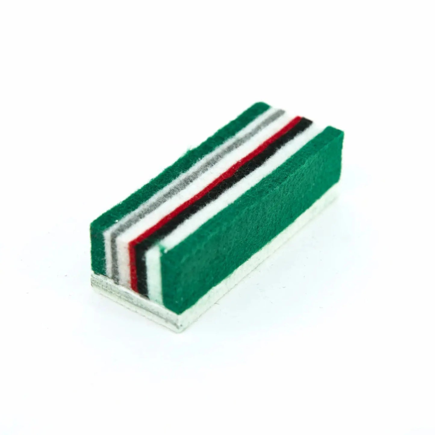 Rectangular eraser with green, red, and black stripes on a white background