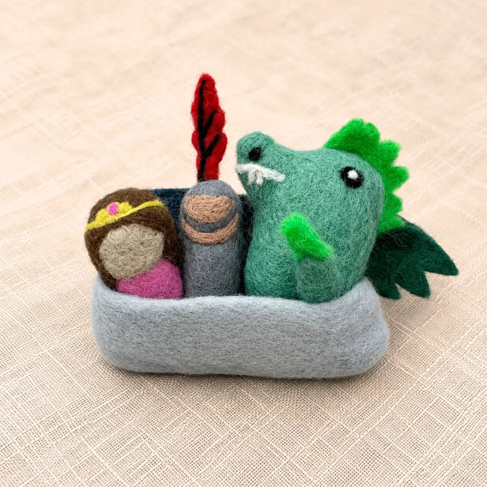 Felt castle pocket play set with princess, knight, and dragon tucked inside a soft wool castle pouch.