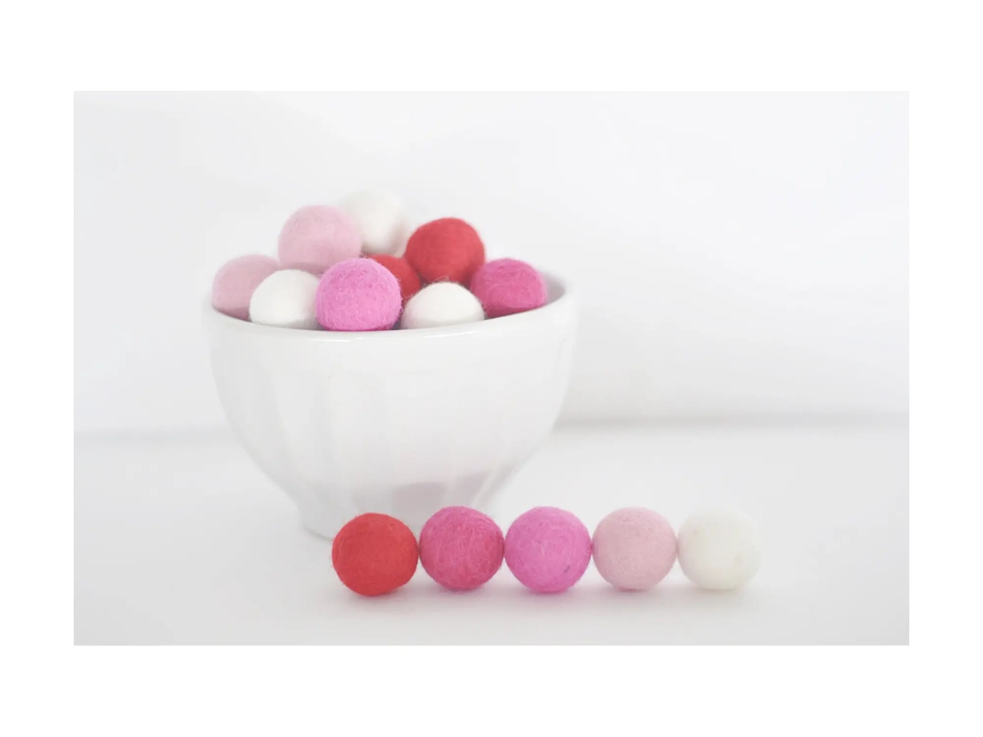felt wool balls in red pink and white for valentine crafts garlands and seasonal decorations