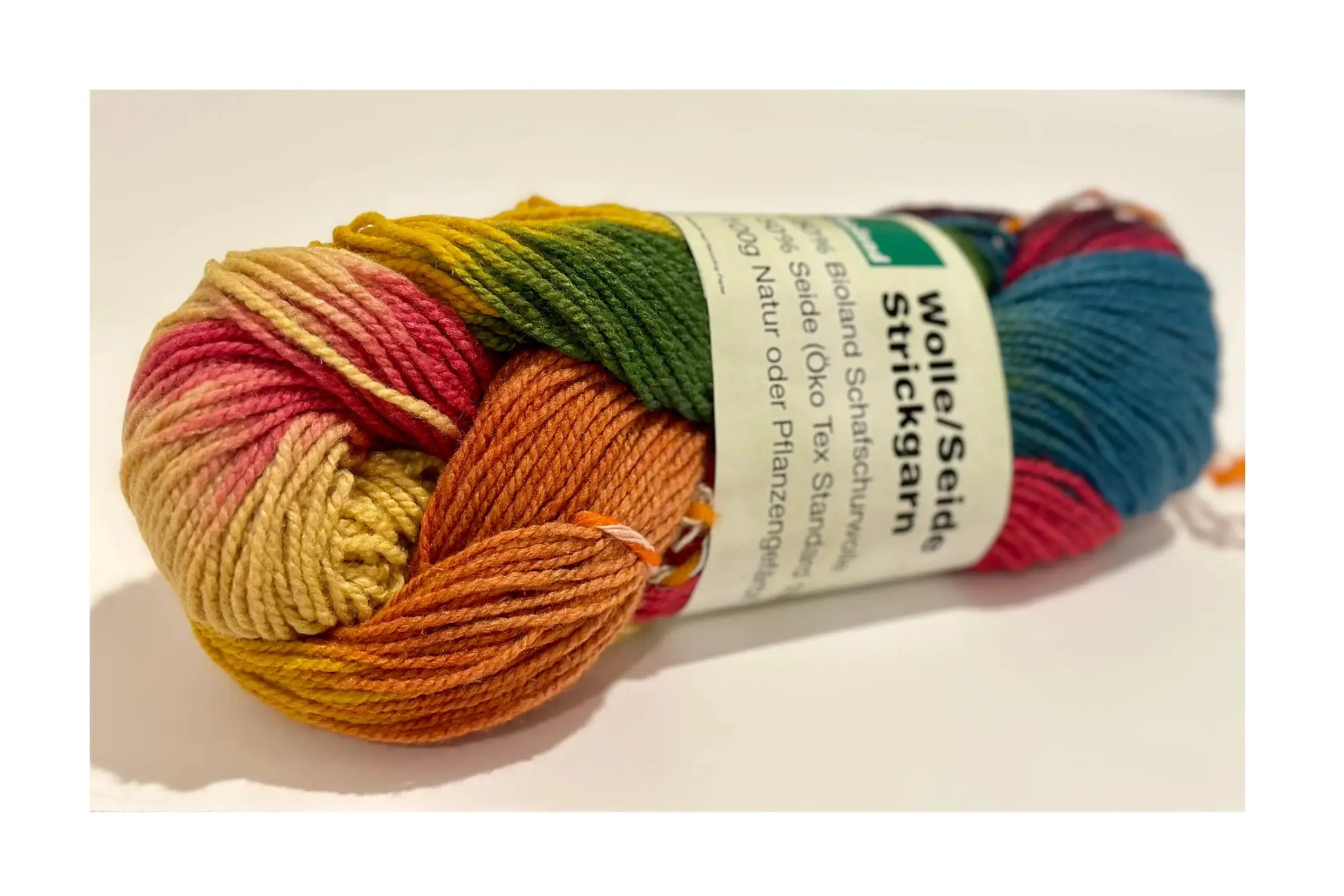 Organic Wool & Silk Plant Dyed Rainbow Yarn close up of plant dyed rainbow effect on a light background