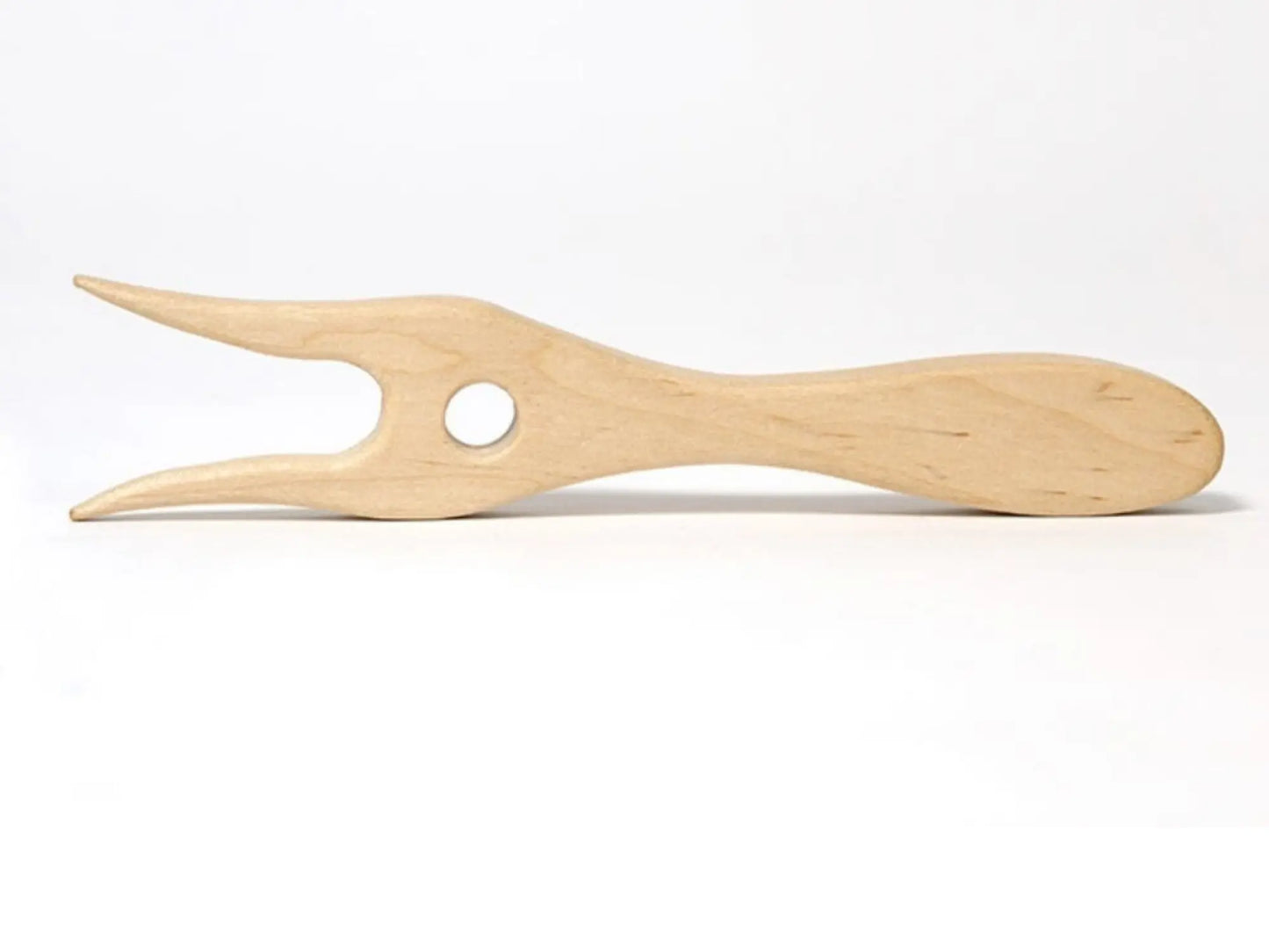 Close up of a natural wood lucet braiding fork on a white background