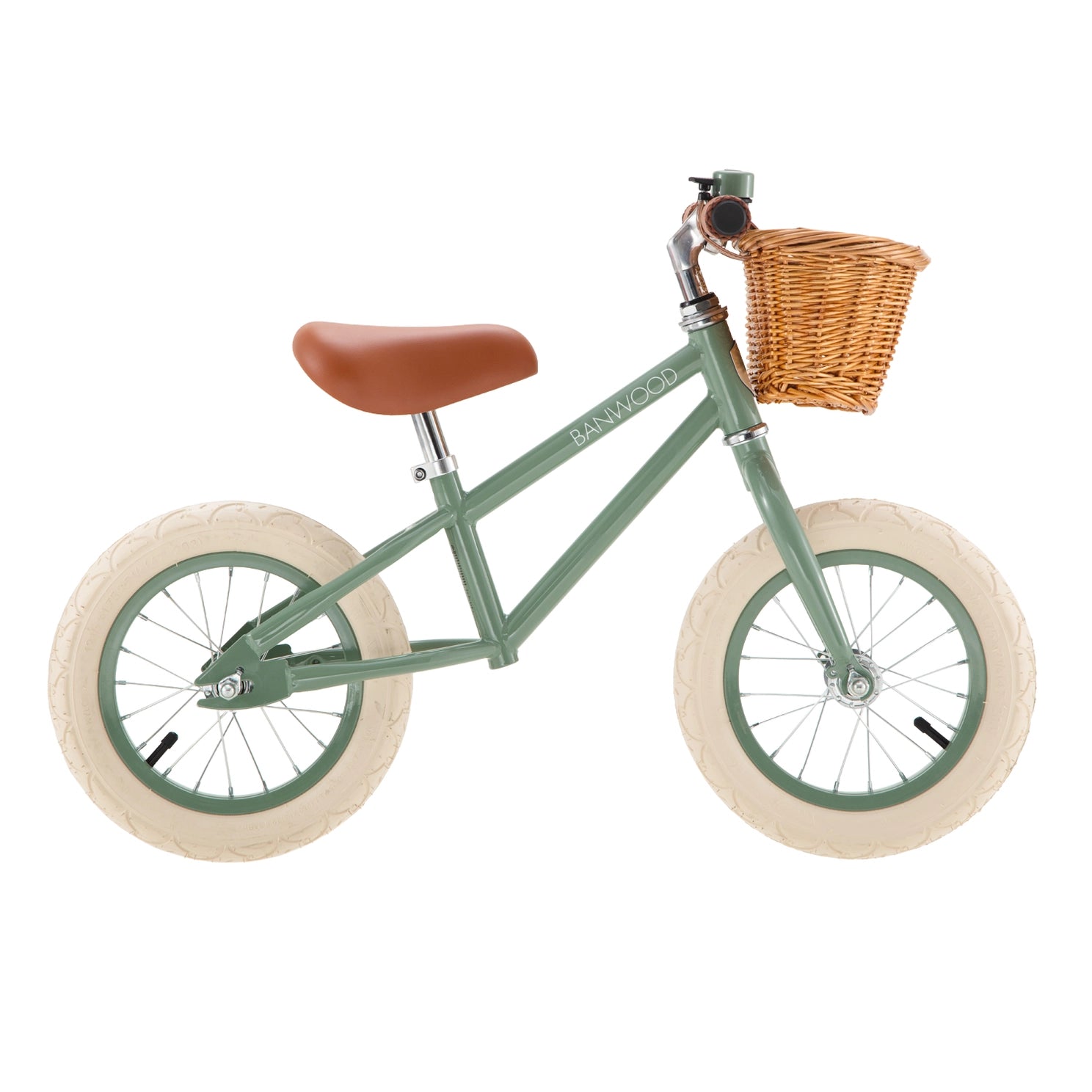 Green balance bike with a brown seat and wicker basket on a white background