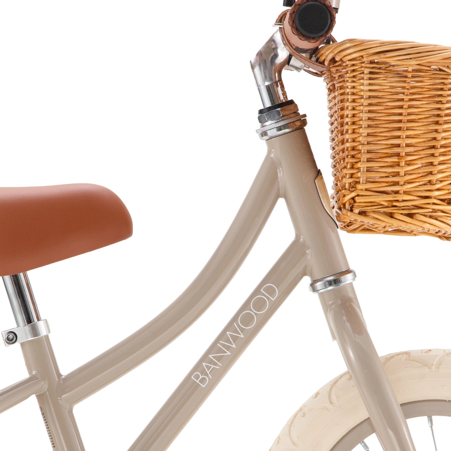 Beige bicycle with a wicker basket and brown seat on a white background