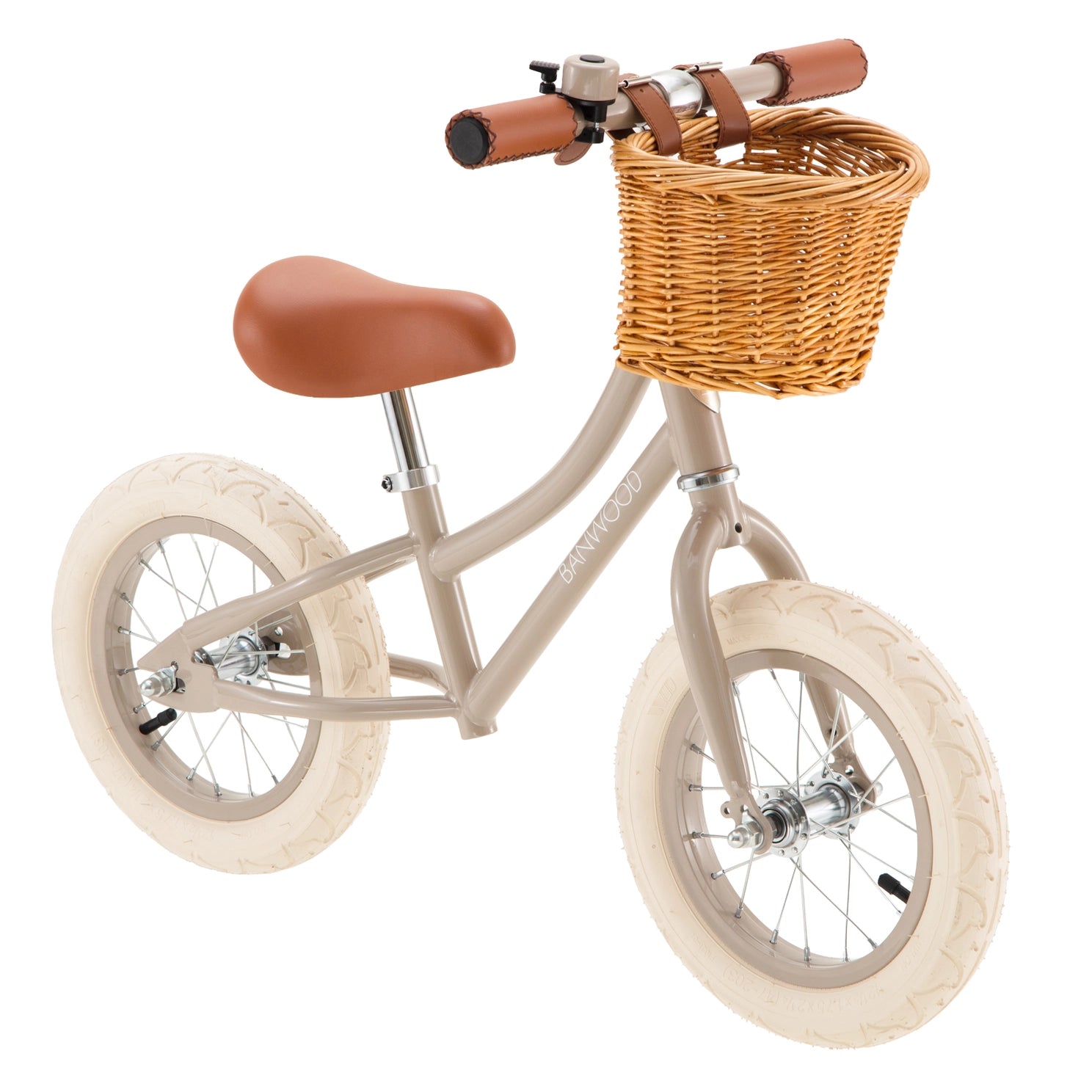 Children's balance bike with wicker basket and brown seat on a white background