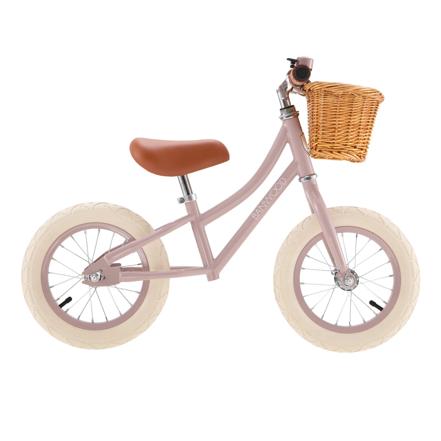 Pink balance bike with a wicker basket on a white background