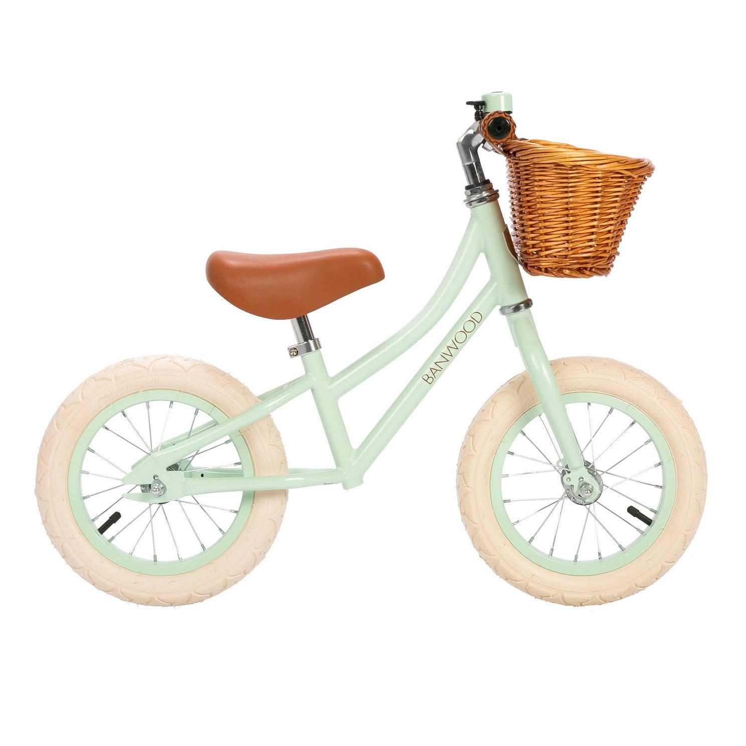 Children's balance bike with a wicker basket on a white background