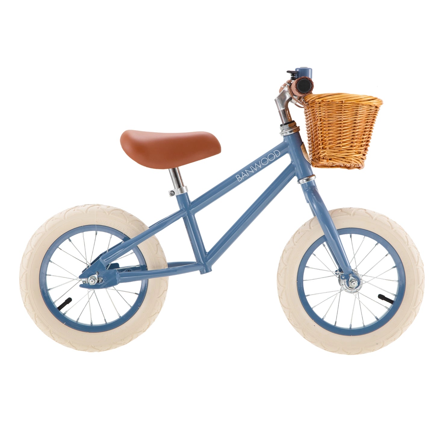 Blue balance bike with a wicker basket on a white background