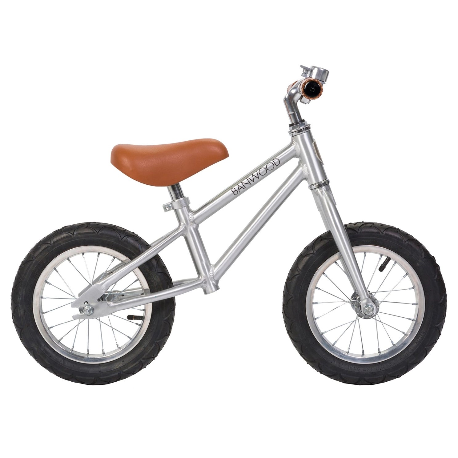 Silver balance bike with brown seat on a white background
